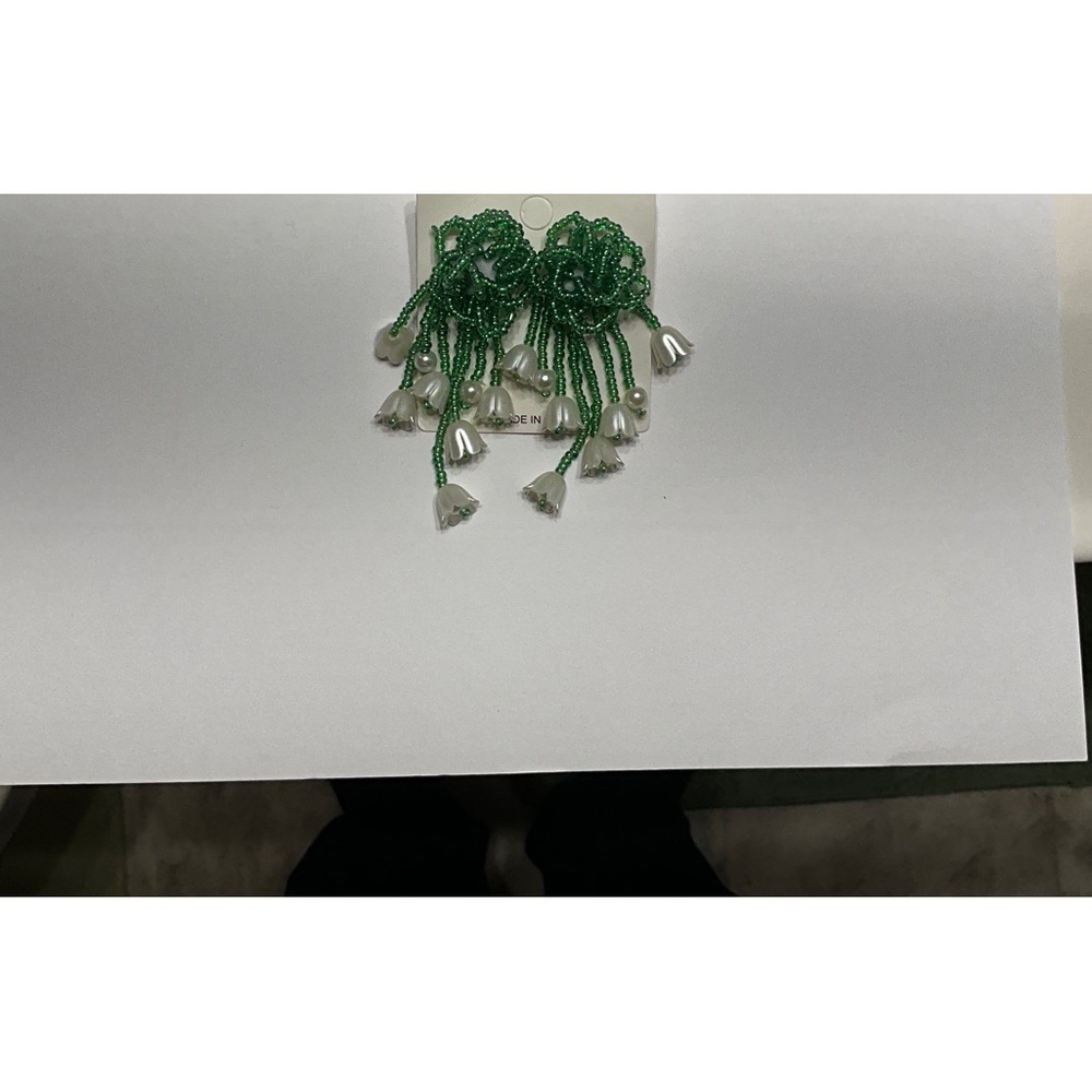 Attention-getting beaded green earrings with Lilly of the Valley flowers.